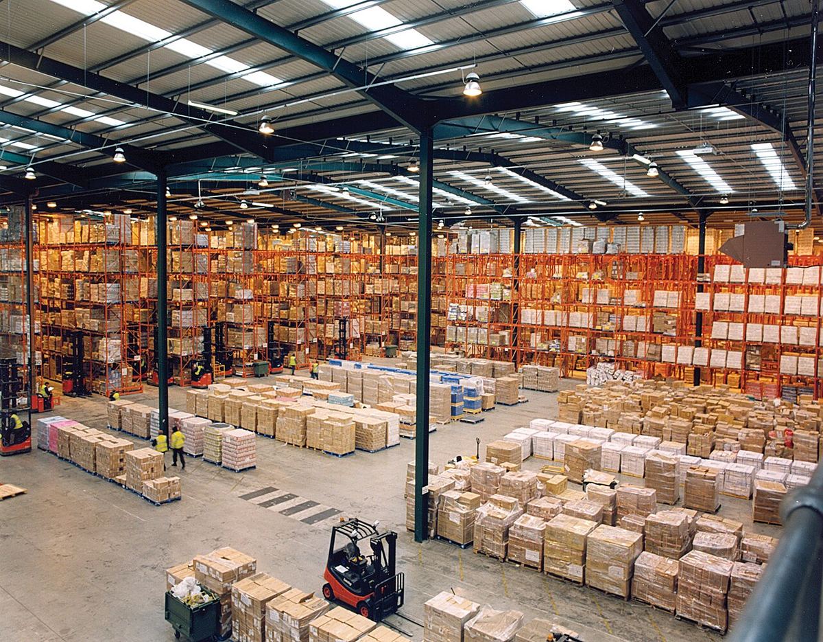 Warehouse interior with tall pallet racks and boxed goods